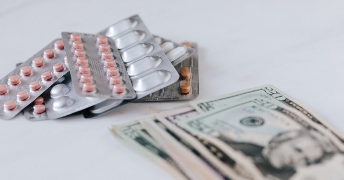 Non-prescription medicines in India and USA - Various pill packages near American dollar bills