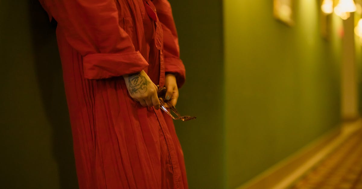 Non-refundable hotel stay - Woman in Red Dress Leaning on the Wall