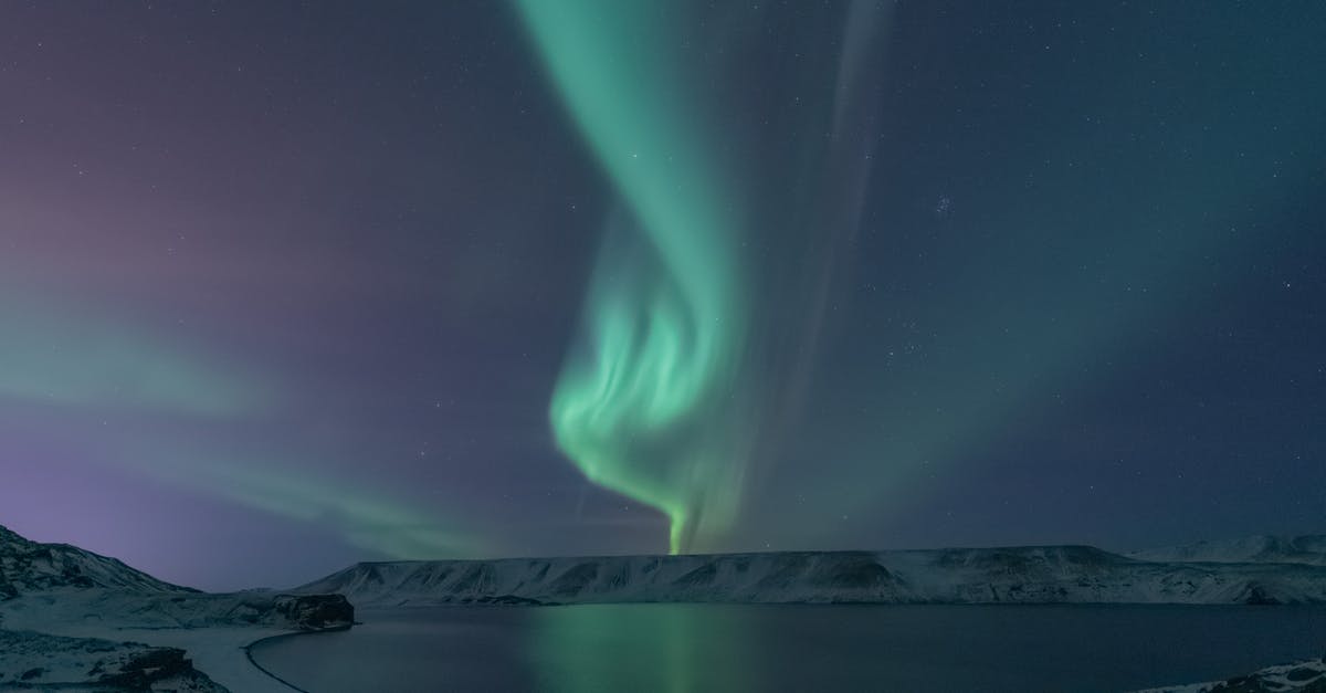 Northern lights in Iceland during March [duplicate] - Northern Lights Above Lake and Snowy Landscape