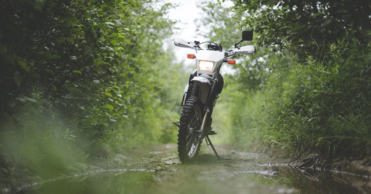 Offroad motorcycling across Australia - A Motorcycle Parked Between Green Trees