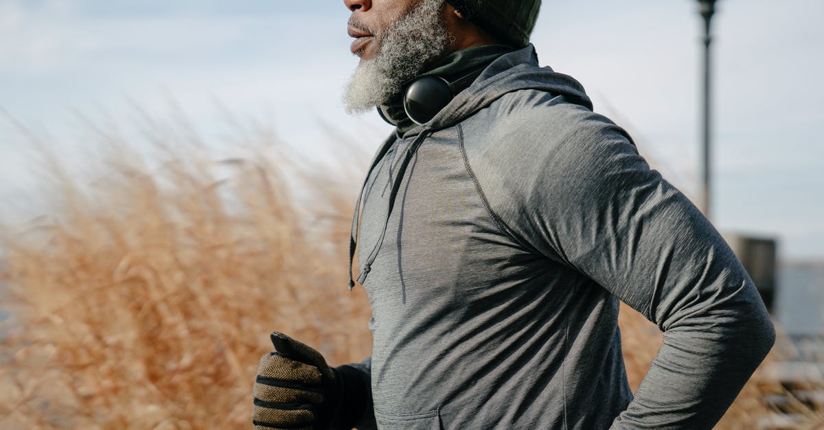 Old passport with Active Visa - Black man in sportswear jogging in sunny autumn day