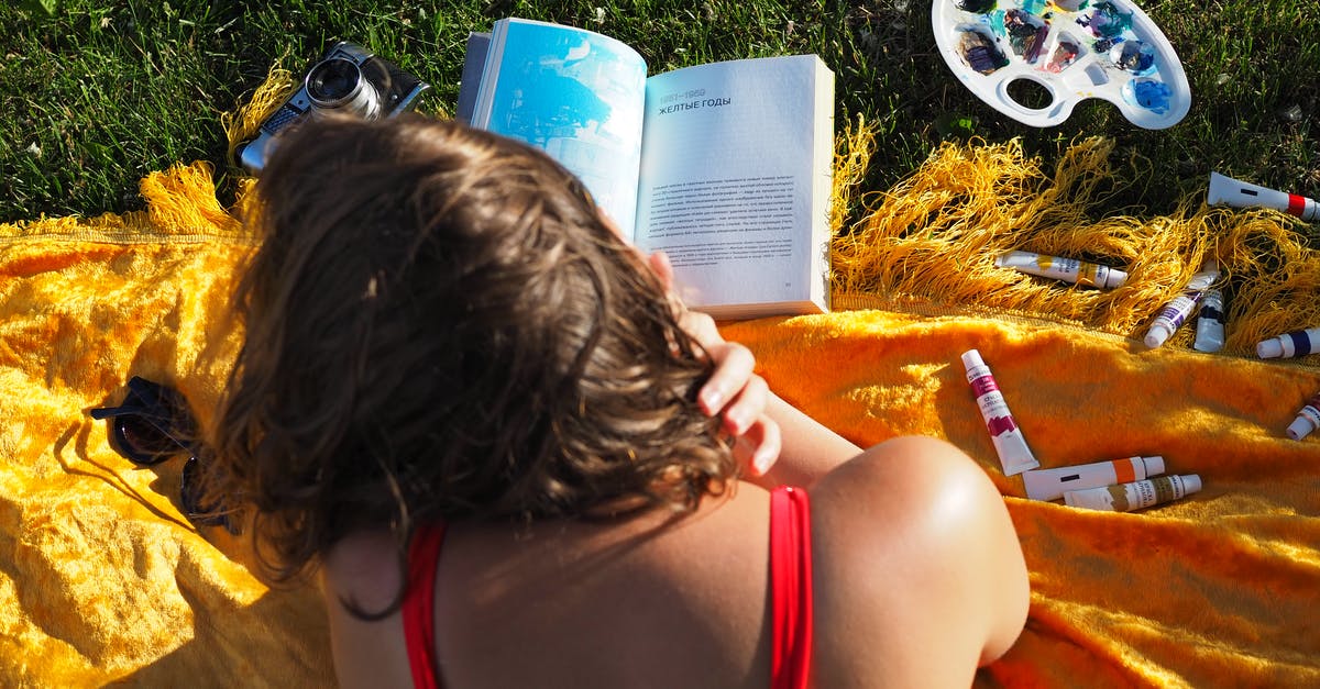 OmegaFlightStore.com, is it reliable to book flights from this site? - A Woman in Red Tank Reading a Book Near the Green Grass