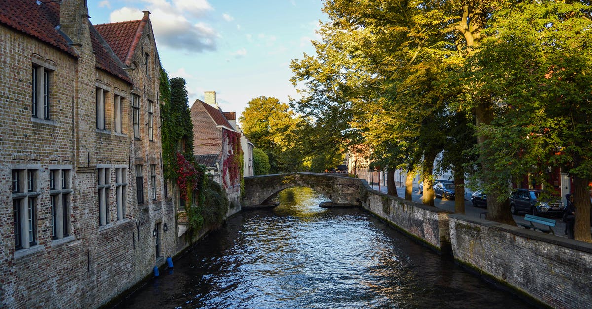On a trip to Belgium, should I stay in Bruges or Ghent? [closed] - Old stone canal houses in aged city