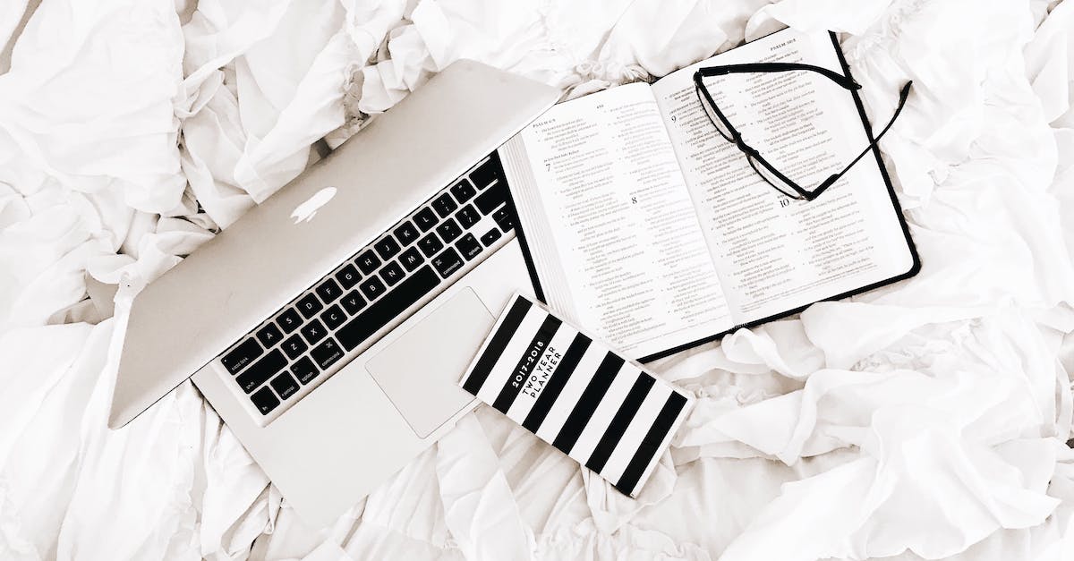 On planning a road-trip [closed] - Eyeglasses on Book Beside Macbook