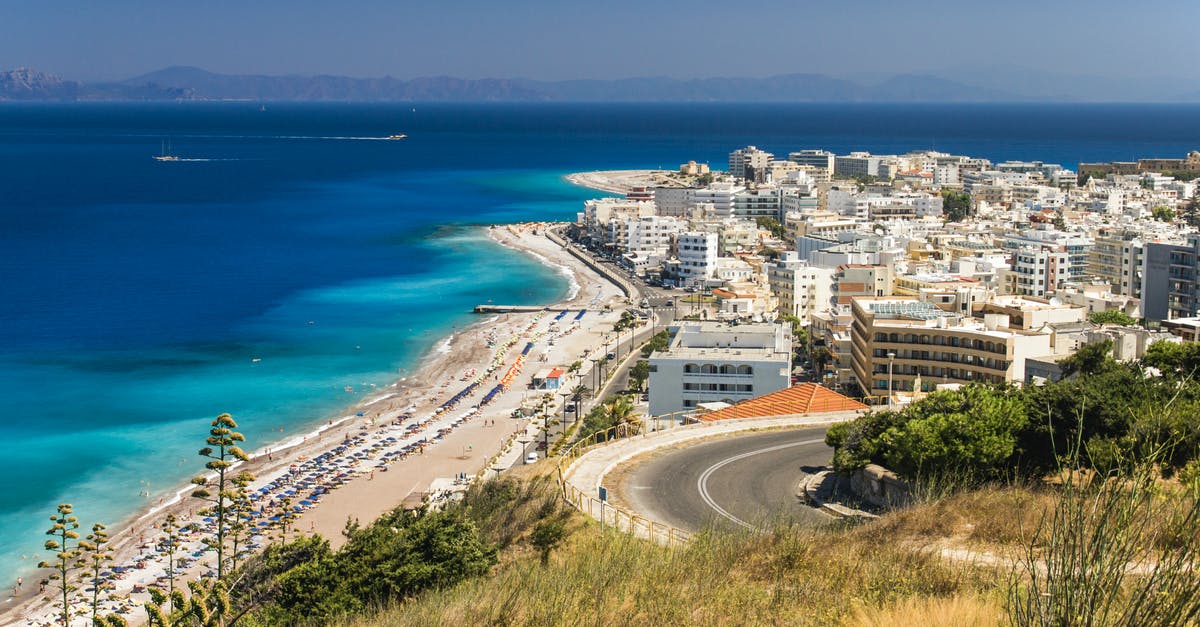 On what basis do the Greek authorities decide how long a passenger entering Greece will stay in quarantine? - Aerial View of City Buildings Near Sea