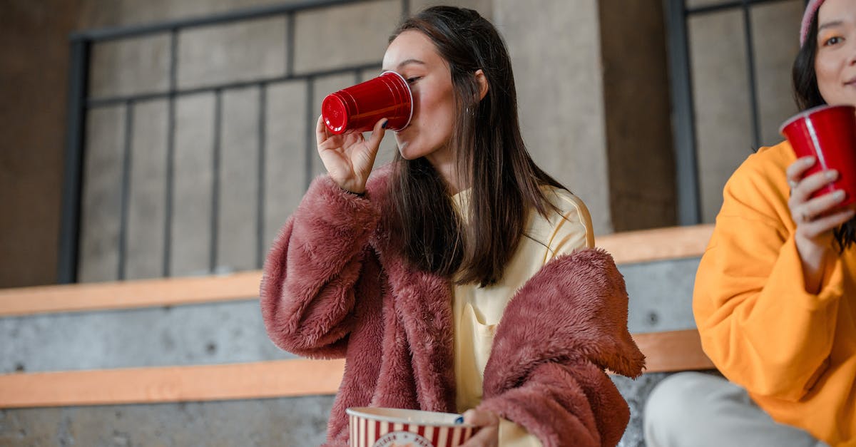 One month in India: eating tips to getting spiced-out - Young Women Drinking and Eating Popcorn at a Get Together