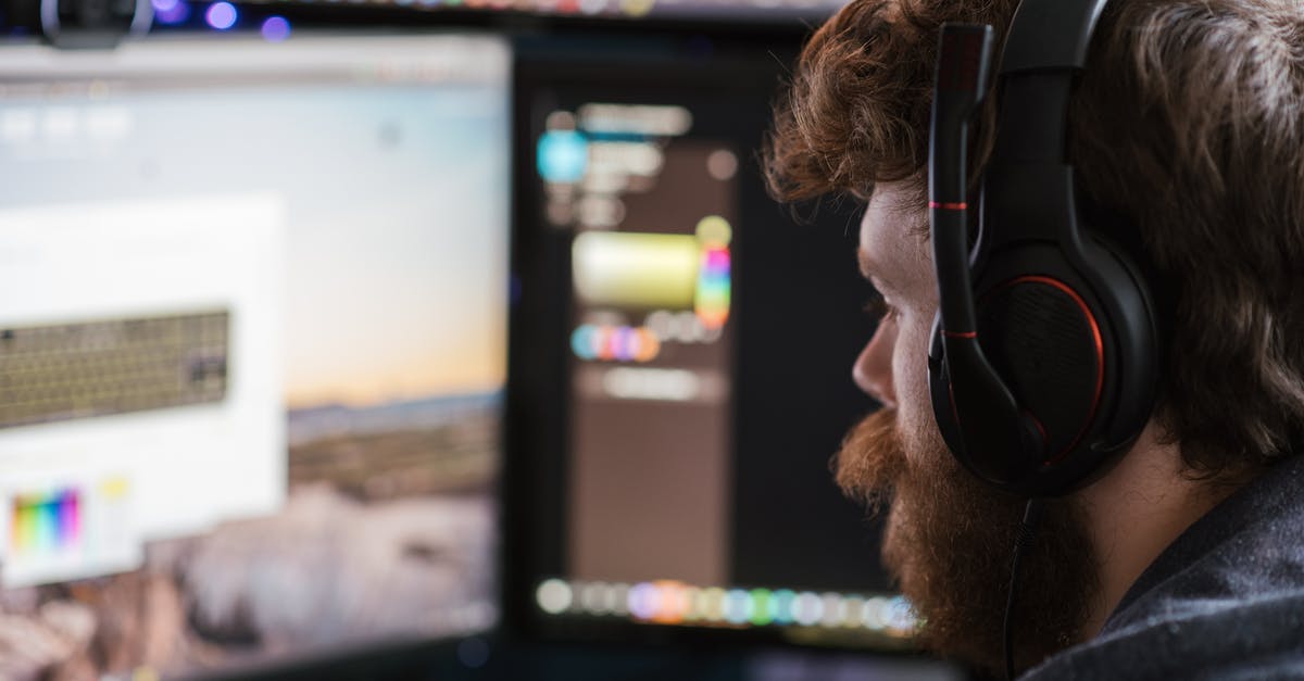 Online booking for flight spanning multiple carriers? - Crop man in headphones working on computer