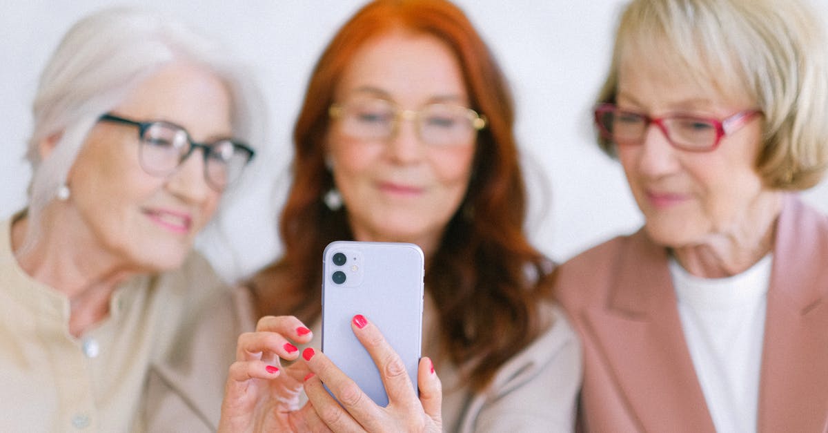 Online check in with group. How will the boarding passes be distributed? - Senior women using smartphone while surfing internet