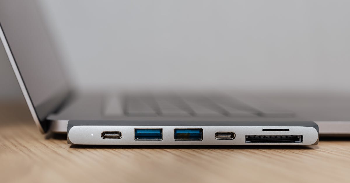 Online cruise search tool allowing to exclude some ports - Space grey type c USB hub with multiple different ports connected to laptop