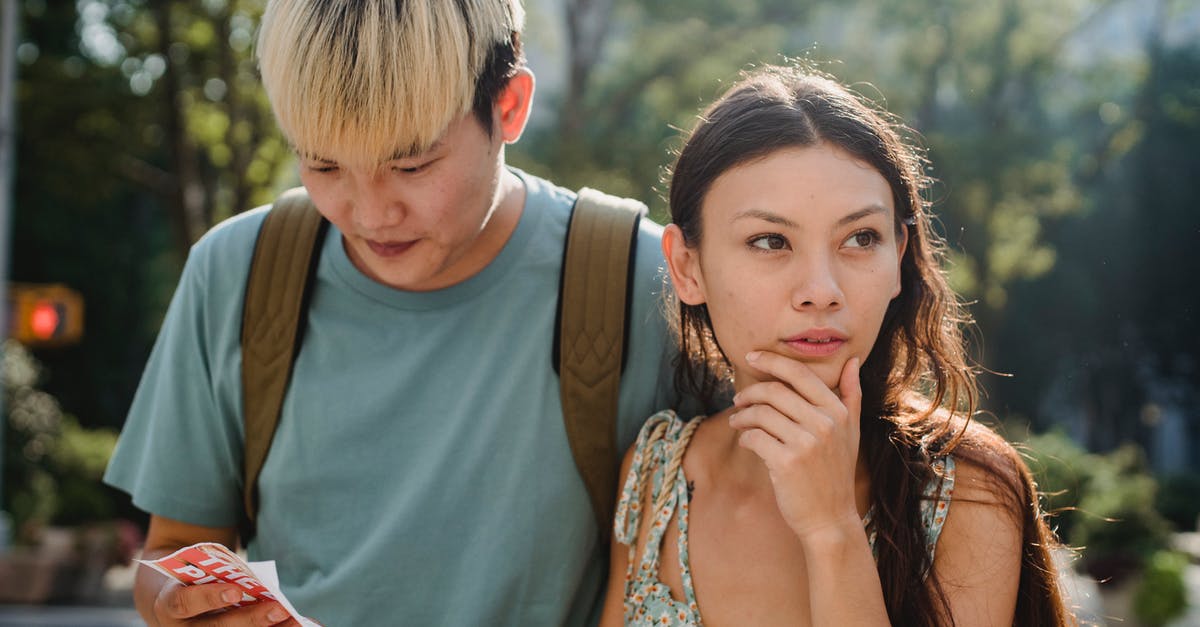 Online tool to find points of interest along a route - Confused multiracial couple searching way in map while discovering city together during summer holidays