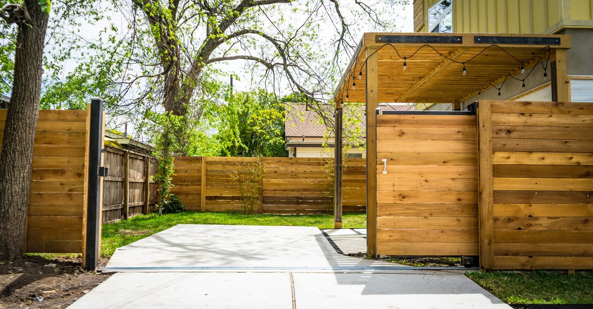 Open gates on the Paris Metro - Photo of Opened Brown Wooden Sliding House Gate