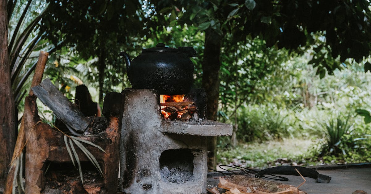 Options for cooking own food while traveling to Canada? - Cooking On A Black Pot Using Firewood