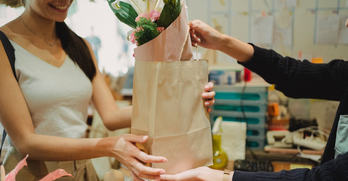 Order Roma Pass online? - Flower shop assistant passing bag with bouquet