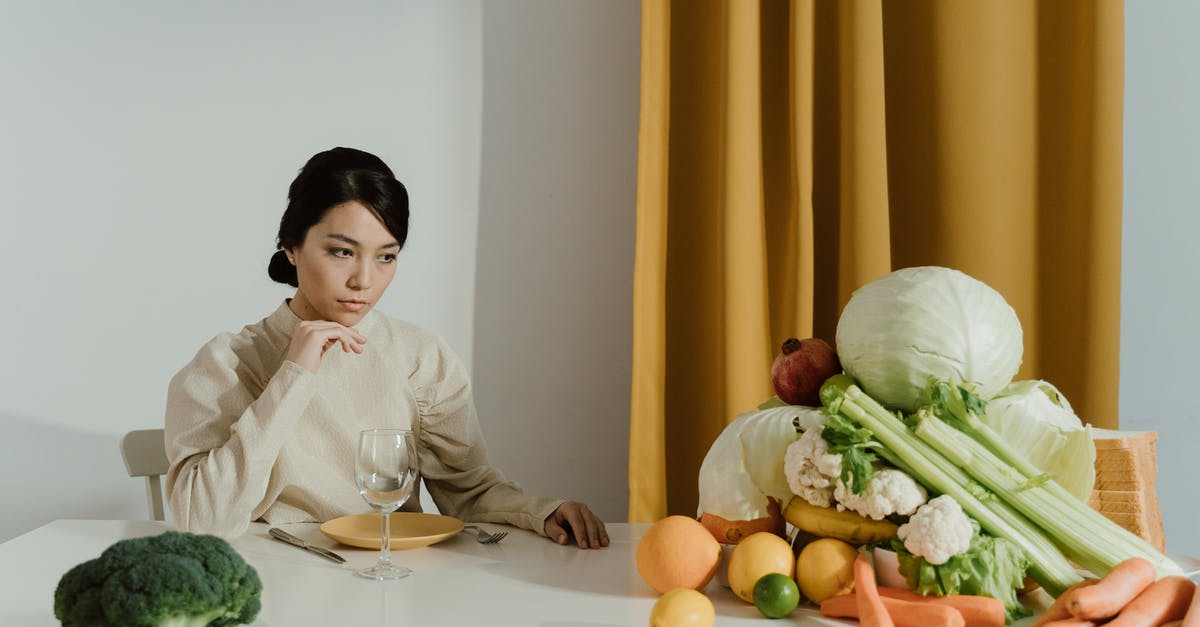 Organic Grocer in Tuscany? - Woman in White Long Sleeve Shirt Sitting Beside White Table With Vegetables