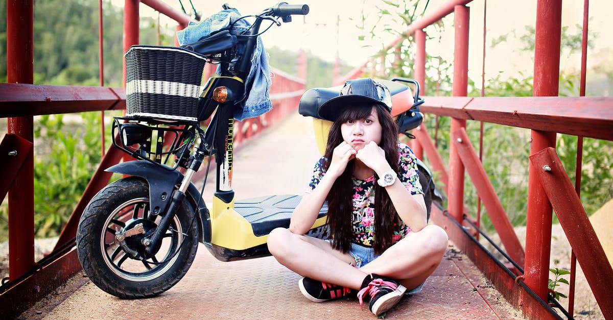 Organized trips for young single travelers? [closed] - Woman Sitting on Bridge With Motor Scooter