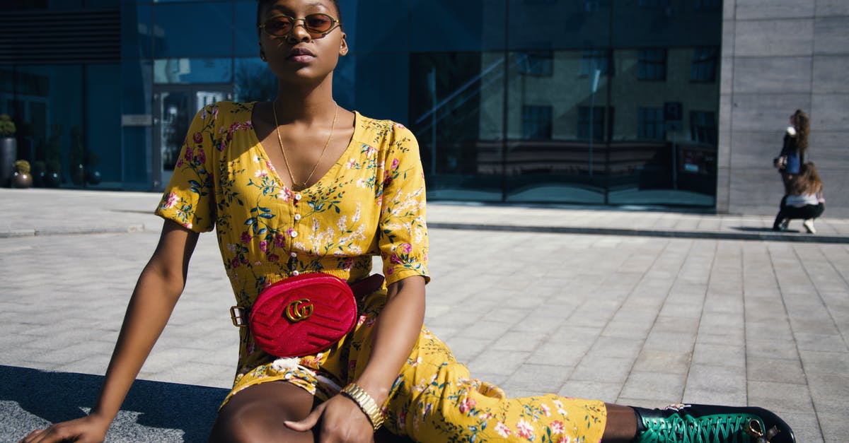 Outdoor clothing and shoes brands that people wear in Iceland [closed] - Woman in Yellow Floral Jumpsuit Sitting on Concrete Floor