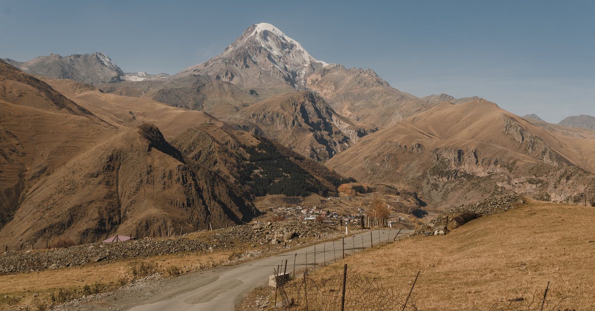 Outgoing ticket when leaving China by land - Brown and White Mountains Under Blue Sky