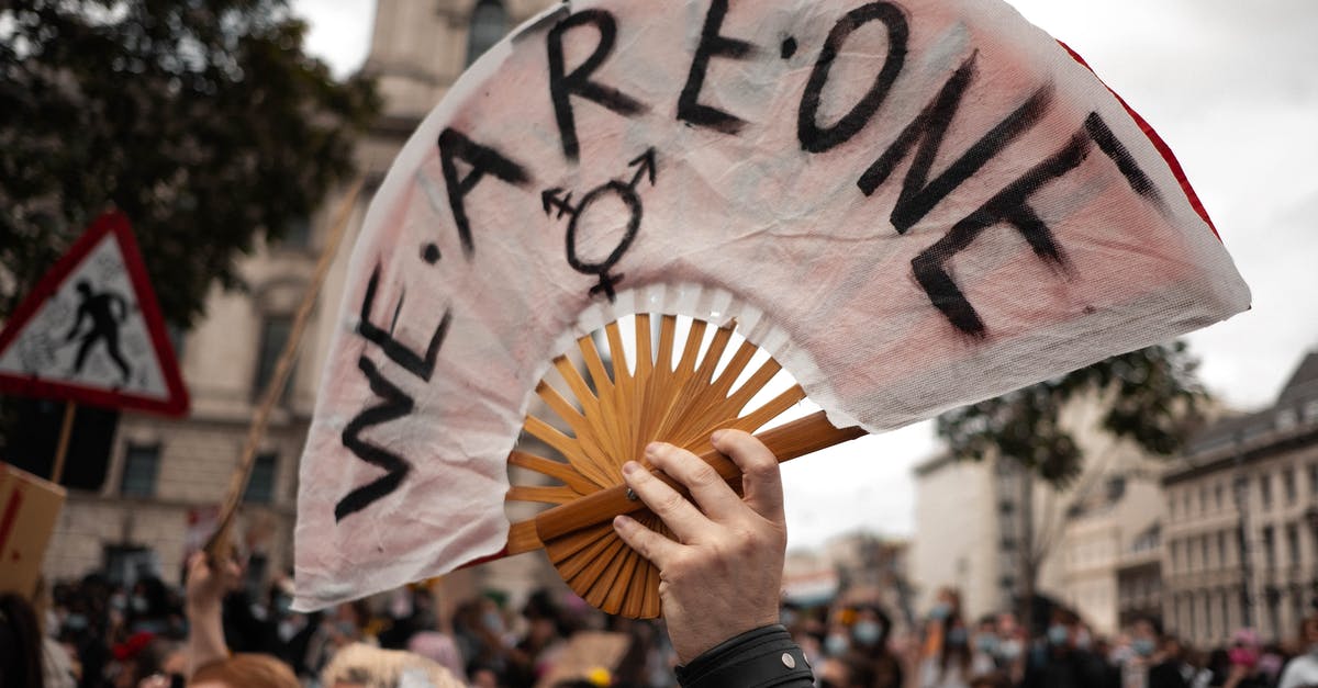 Overnight layover in Toronto as of early June 2020? - Person Holding White and Black Hand Fan