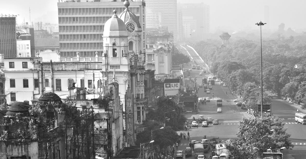 Overstay In India - Grayscale Photo of City Buildings