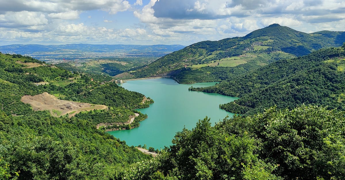 Overstayed in Turkey - Green Lake Surrounded by Green Trees Under Blue Sky