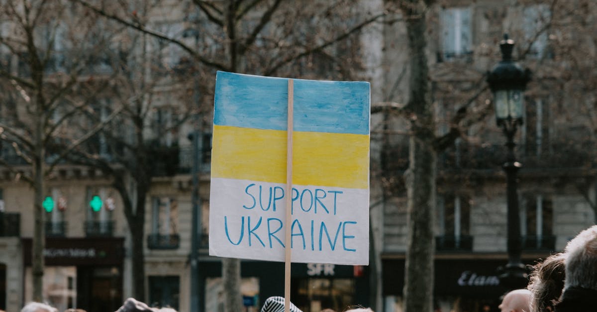 Overstayed in Ukraine - Large Group of People Holding Banner on Supporting Ukraine