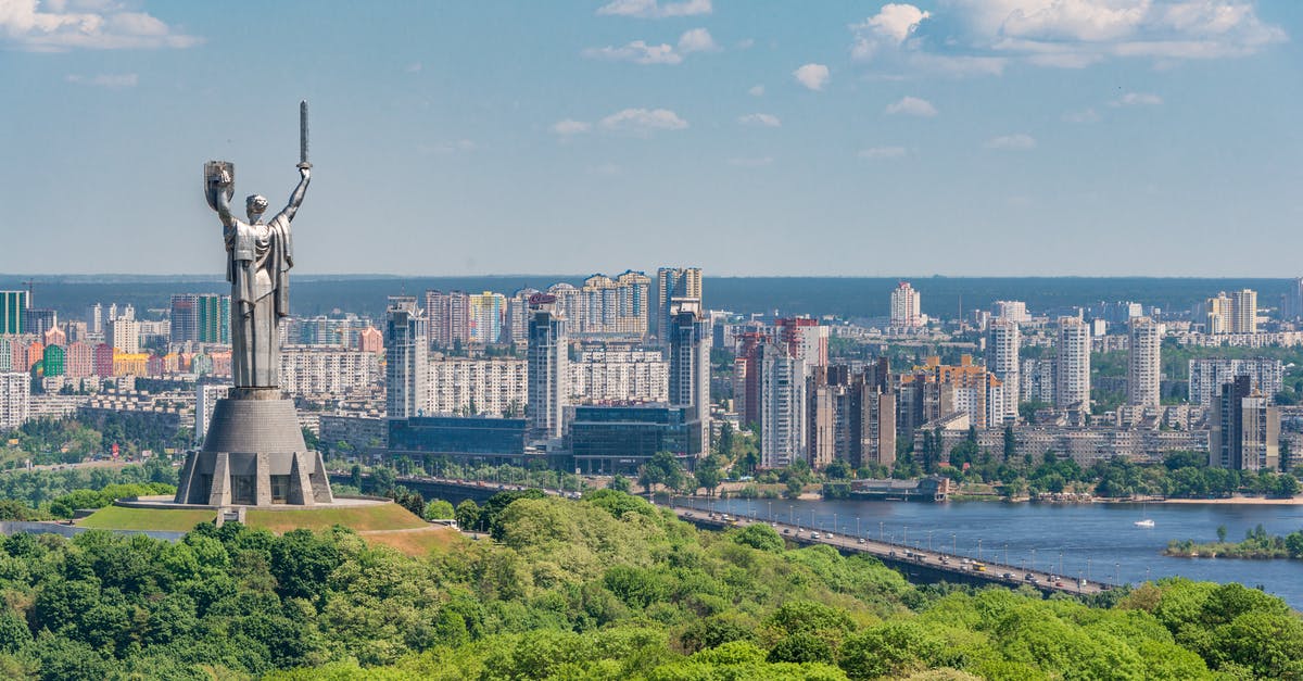 Overstayed in Ukraine - Motherland Monument among green trees on embankment in Kiev