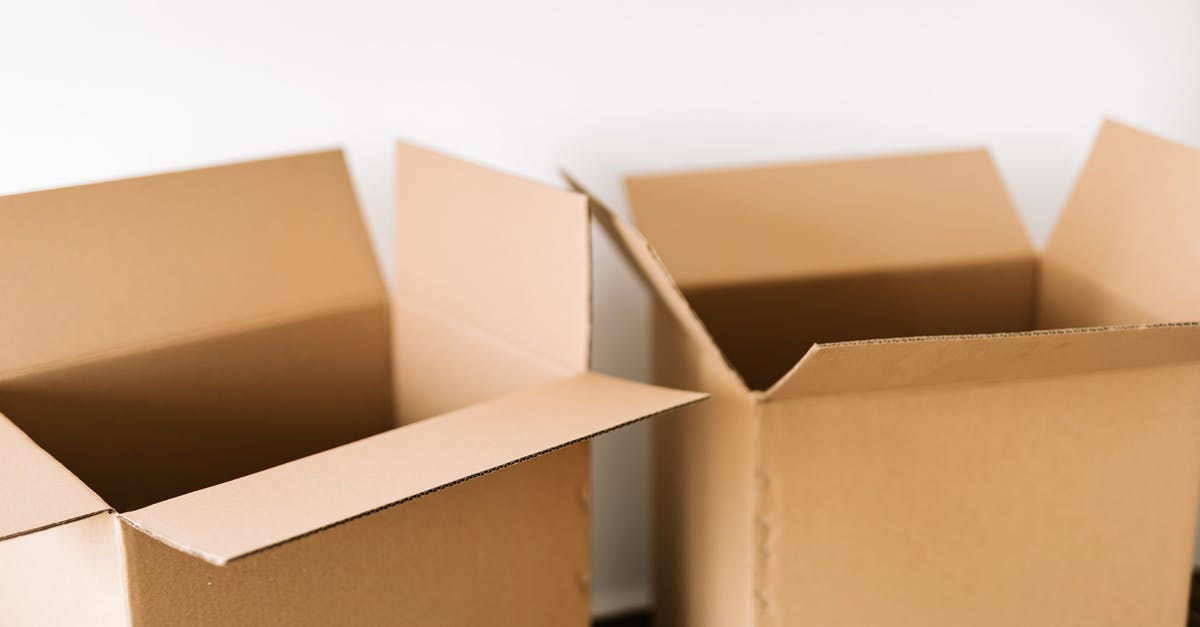 Package-deal or plain ticket + hotel booked separately? - Opened carton boxes placed on dark surface against white plain wall in daylight before moving out