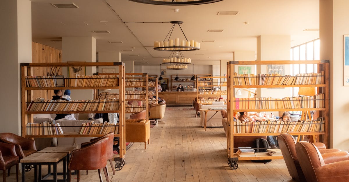 Package-deal or plain ticket + hotel booked separately? - Hotel Lobby with Mobile Bookshelves and Leather Chairs