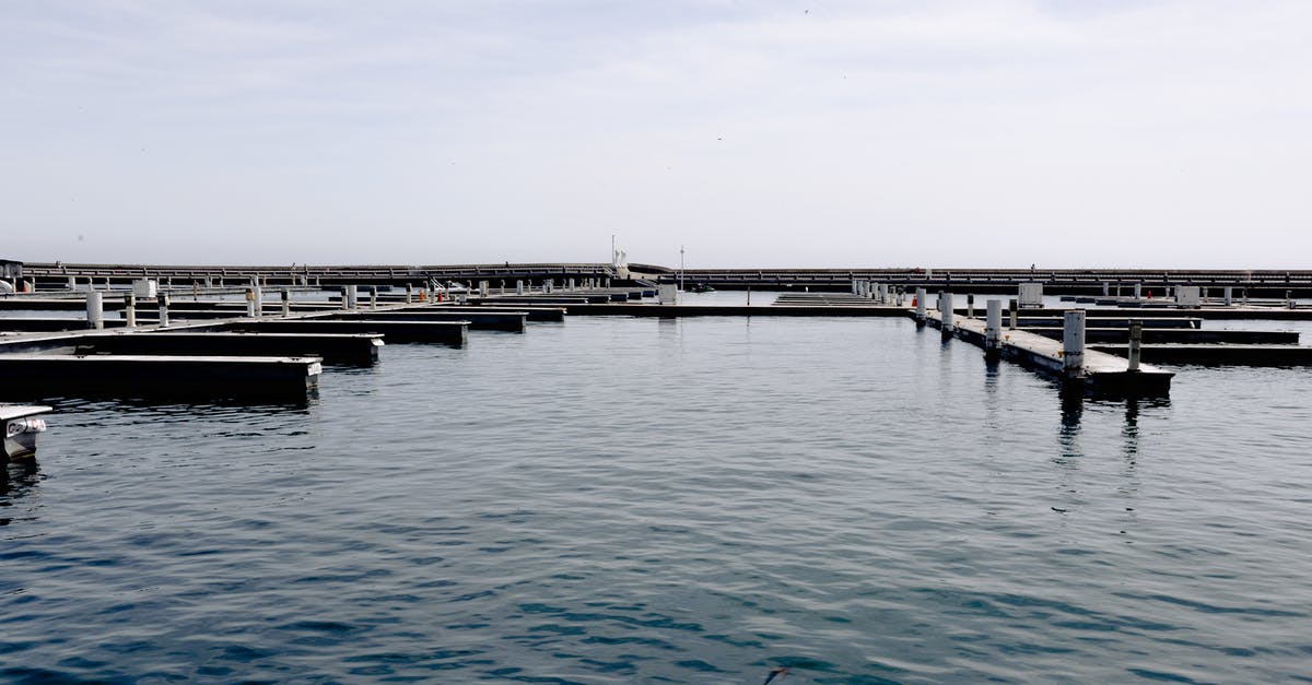 Paid parking on holiday in Czechia - Sea water with empty lots for yachts and boats parking in harbor against cloudy sky