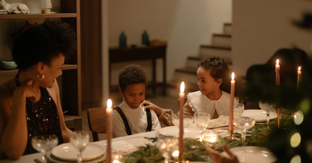 Paris in Jan Christmas decorations - Boy in Black and White Long Sleeve Shirt Sitting Beside Boy in Black and White Long