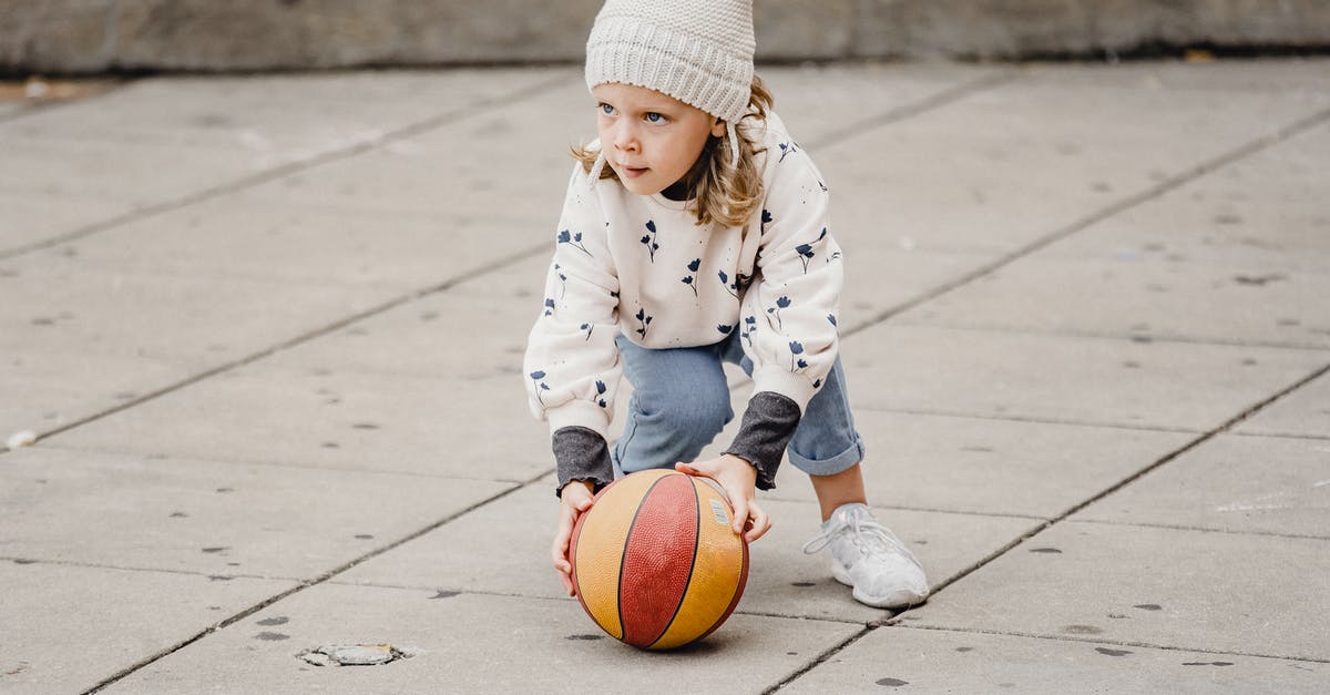 Park City, Utah for vacation - Girl playing with ball on street