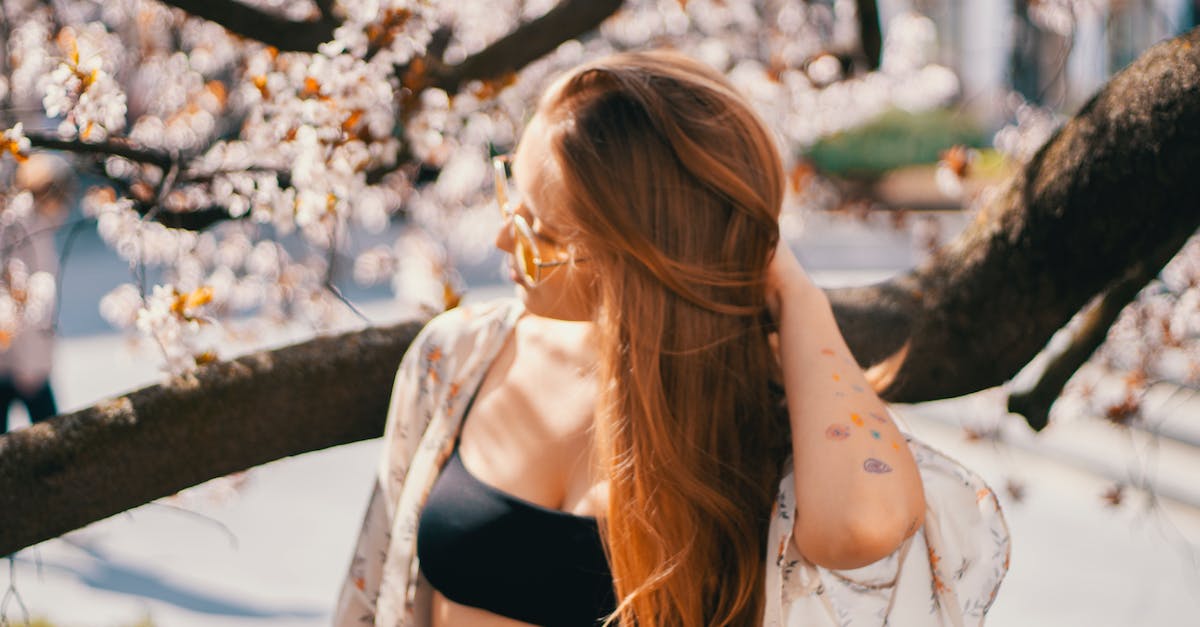 Park City, Utah for vacation - Young woman in summer garden with blooming trees