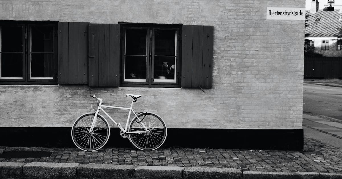 Parking in Copenhagen - White Bicycle Parked on a Roadside Made of Bricks