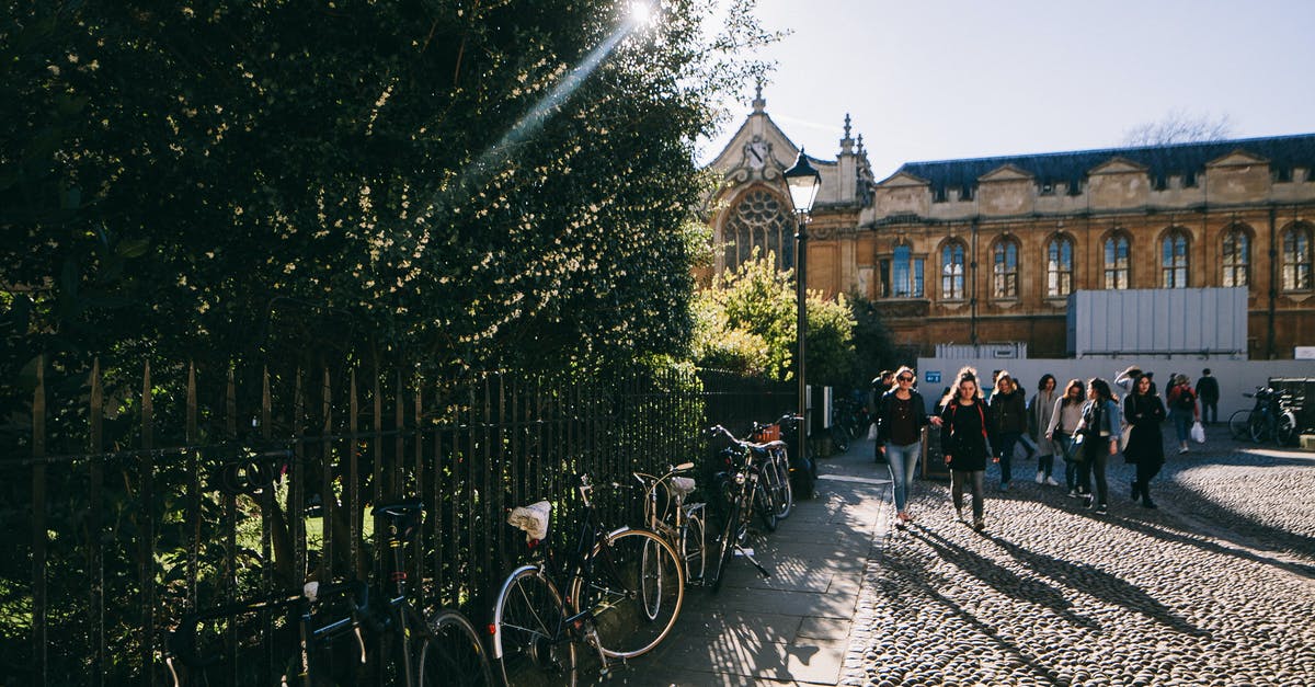 Parking in Oxford - People Walking on the Sidewalk Near a Brown Building