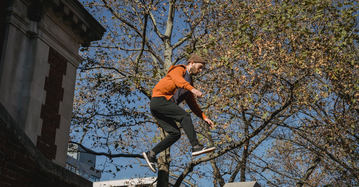 Parkour - Tricking - Free-running in Tokyo? - Active male tracer jumping above brick building staircase