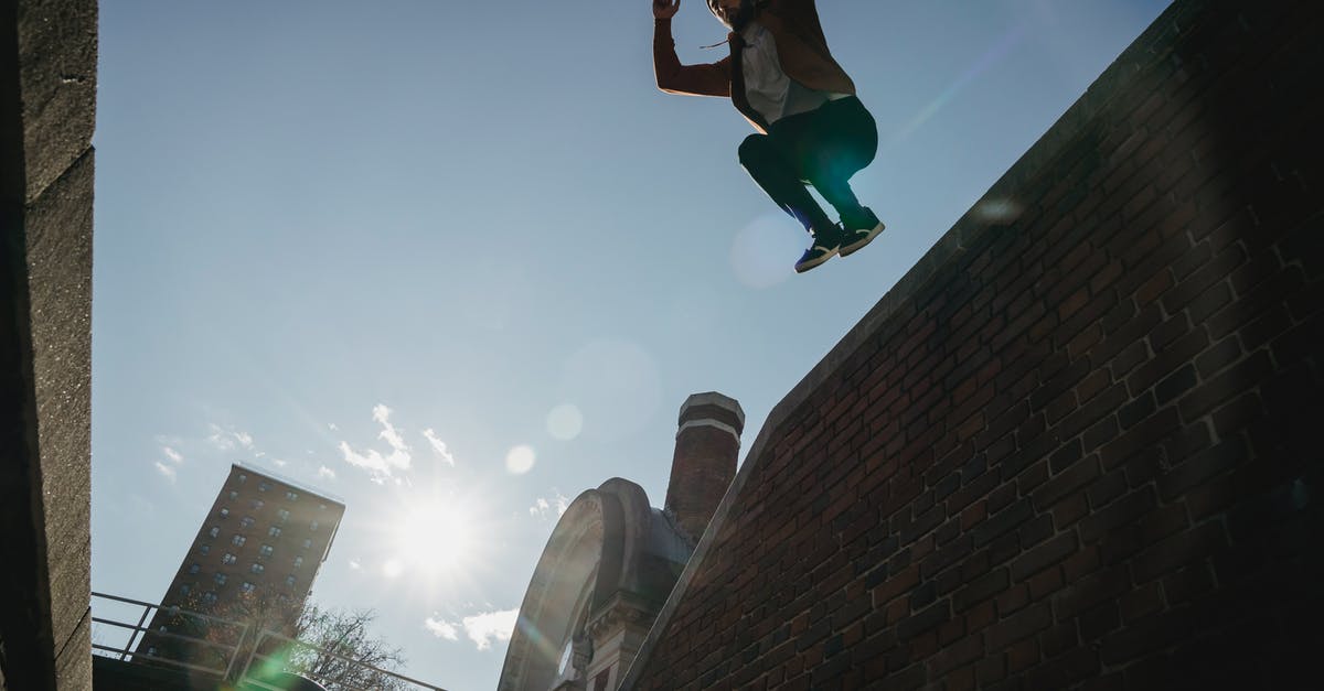 Parkour - Tricking - Free-running in Tokyo? - Determined male tracer jumping from brick wall