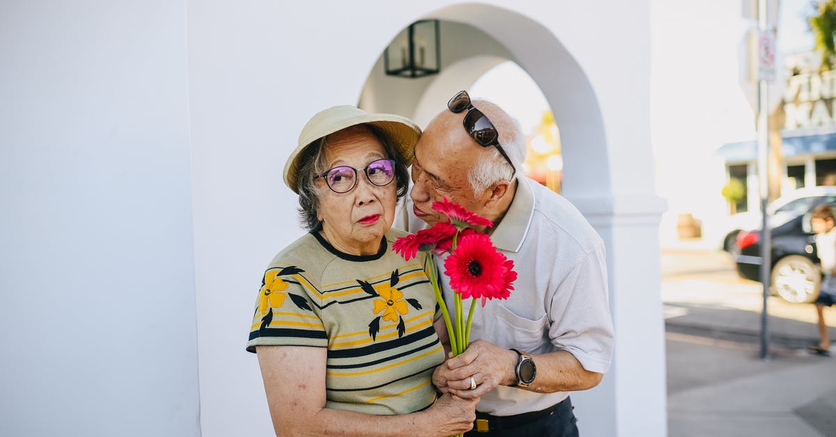 Passport 10 years old on the date I am travelling - Old Man Kissing Her Wife While Giving A Bouquet Of Flowers