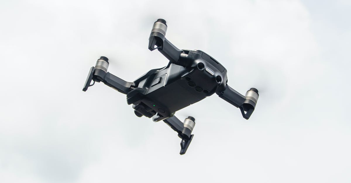 Passport control when flying from Romania to Italy - A Low Angle Shot of a Drone Flying Under the White Clouds