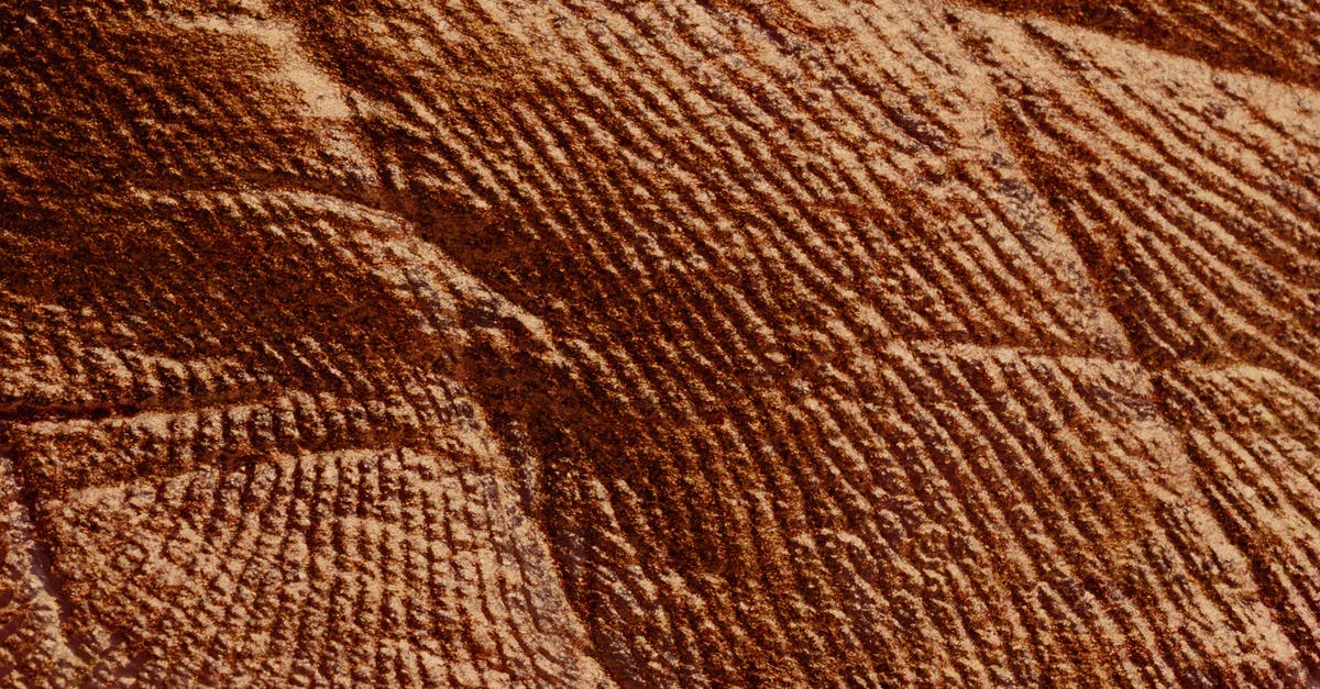 Passport outer cover with slight damage - Closeup of abstract rough textured parget surface of brown color with cracks