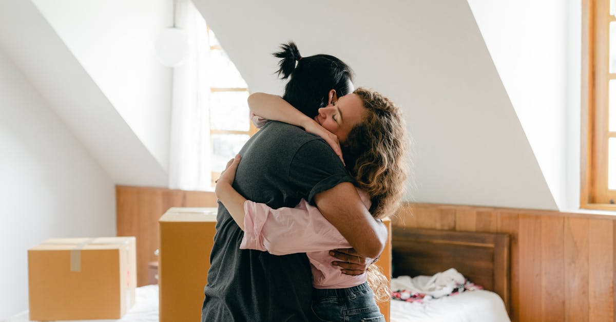 Passport renewal application package questions - Happy couple hugging after moving in new apartment