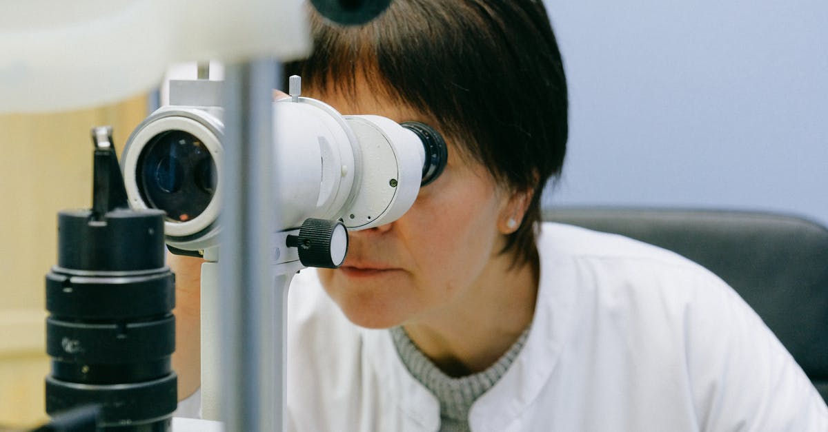 Passport request from IRCC through the VAC office - Photo Of Woman Looking Through Slit Lamp