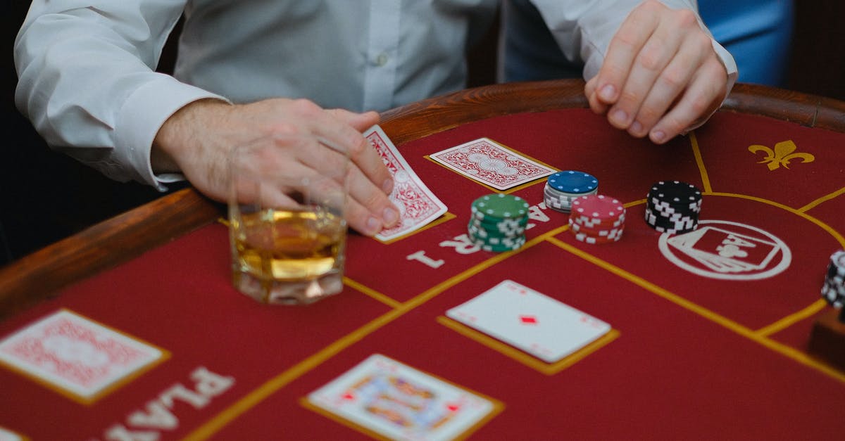 Passport Stamping and Residents cards - A Person Playing Cards on Casino Table