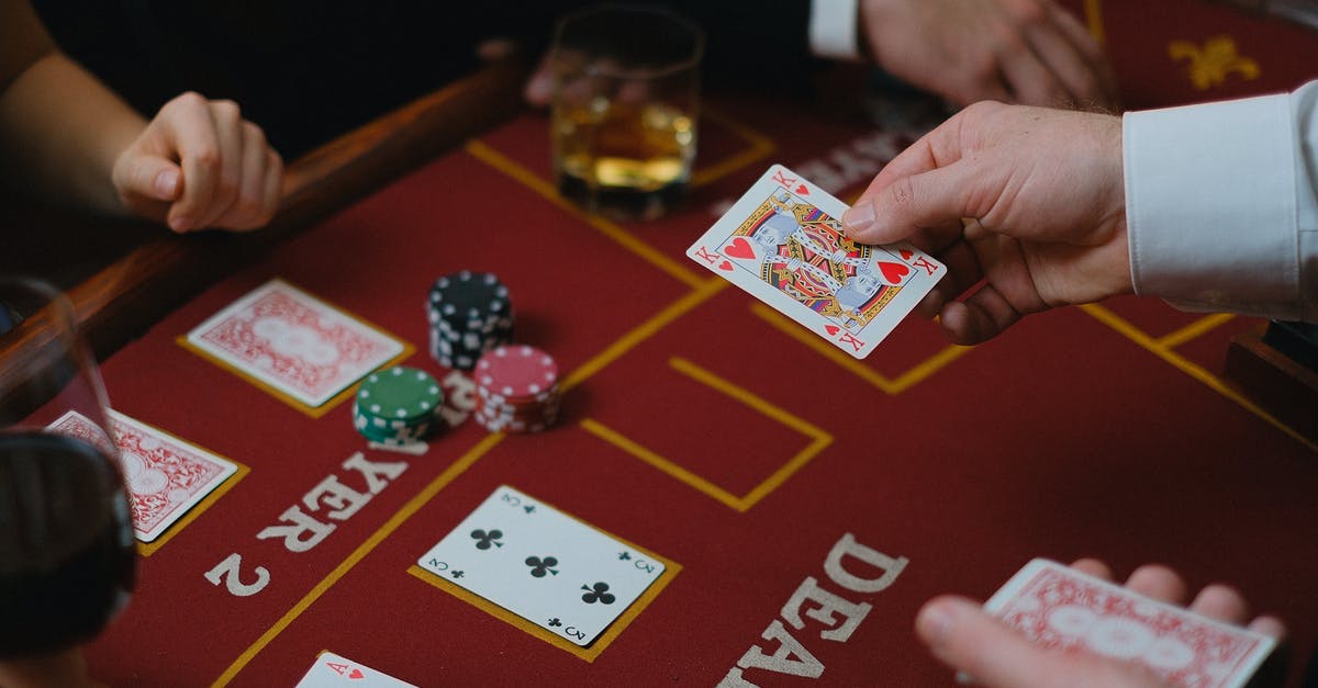 Passport Stamping and Residents cards - Person Holding Red and White Playing Cards