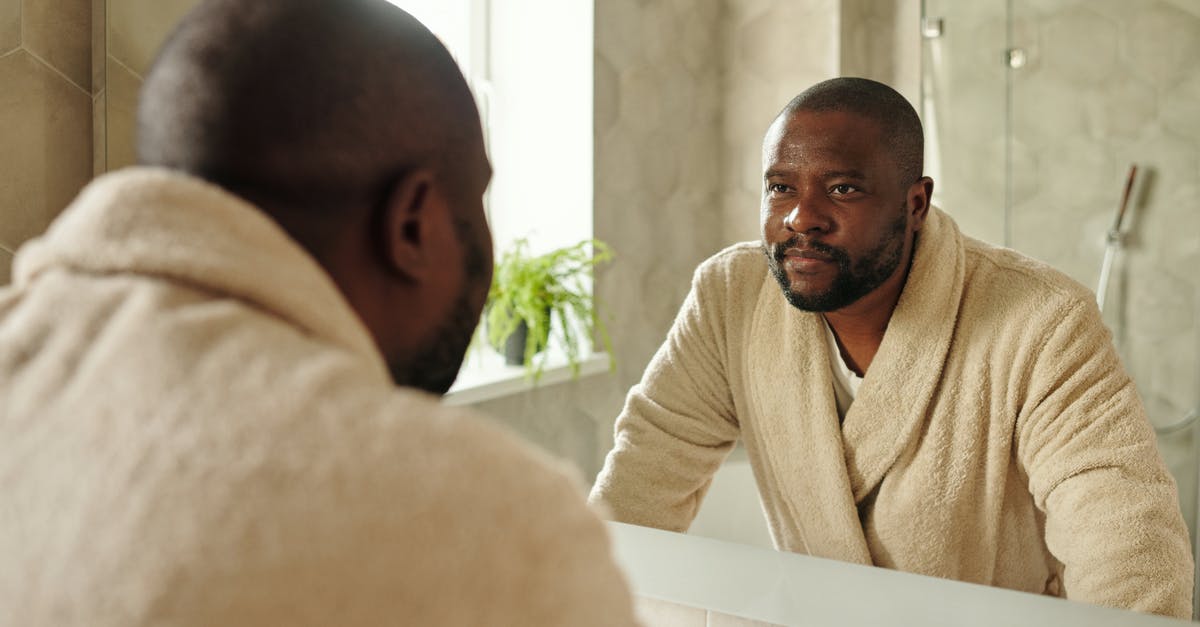 Passport validity inside Schengen Area for African person - Man Wearing Bathrobe Looking at the Mirror