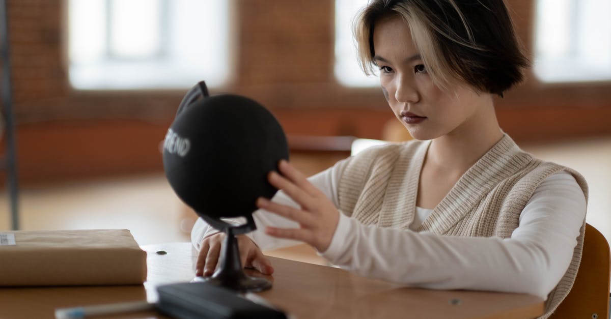 Permesso is not ready and student visa is expired - Woman in White Sweater Holding Black Round Ball