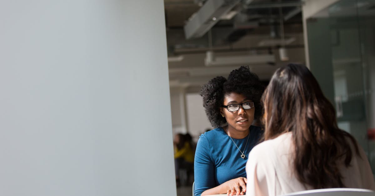 Personal interview requirement for obtaining visa - Woman Wearing Blue Top Beside Table