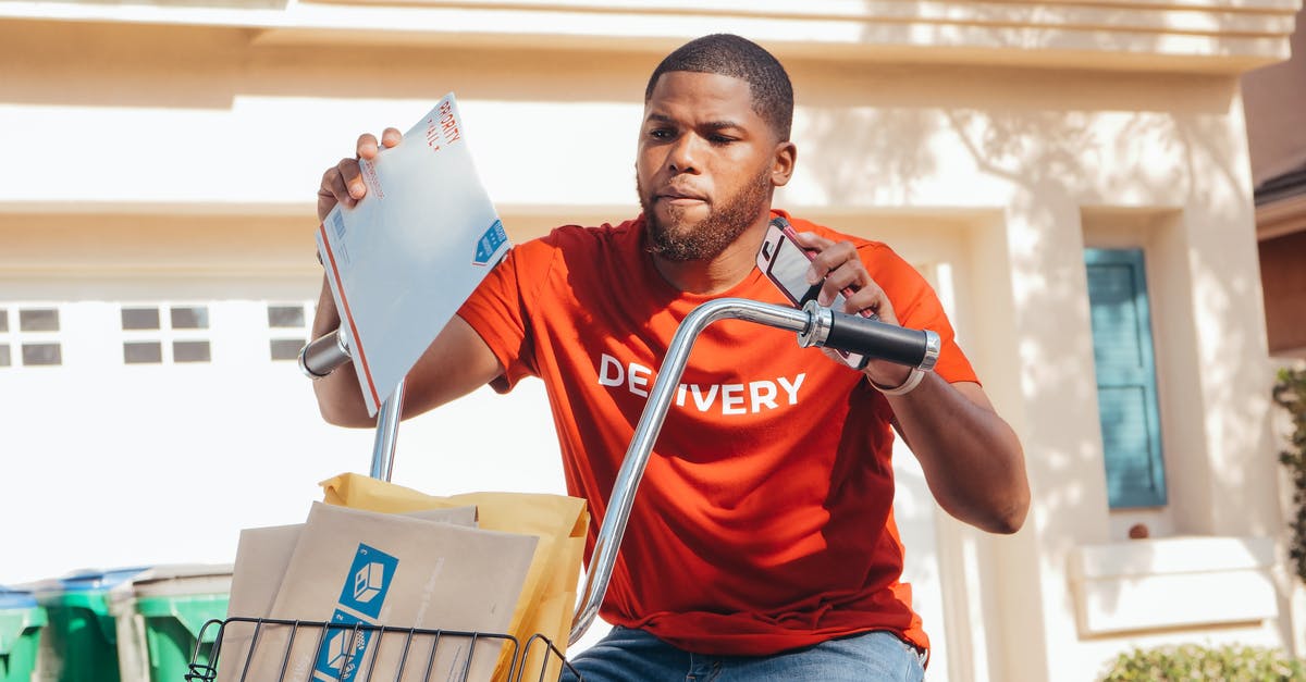 Phone Service while a student in Israel [closed] - Man in Red Crew Neck T-shirt Sitting on Yellow and Black Box