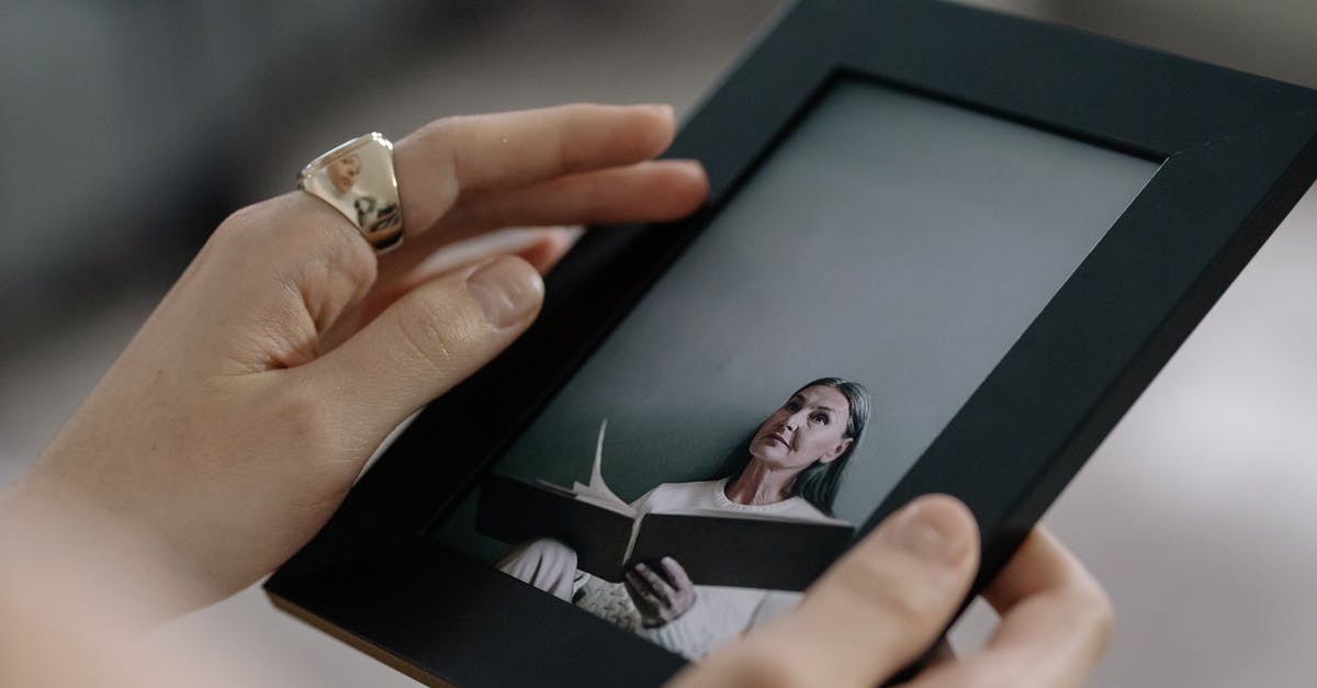 Photo of me holding my passport [closed] - Person Holding Black Picture Frame