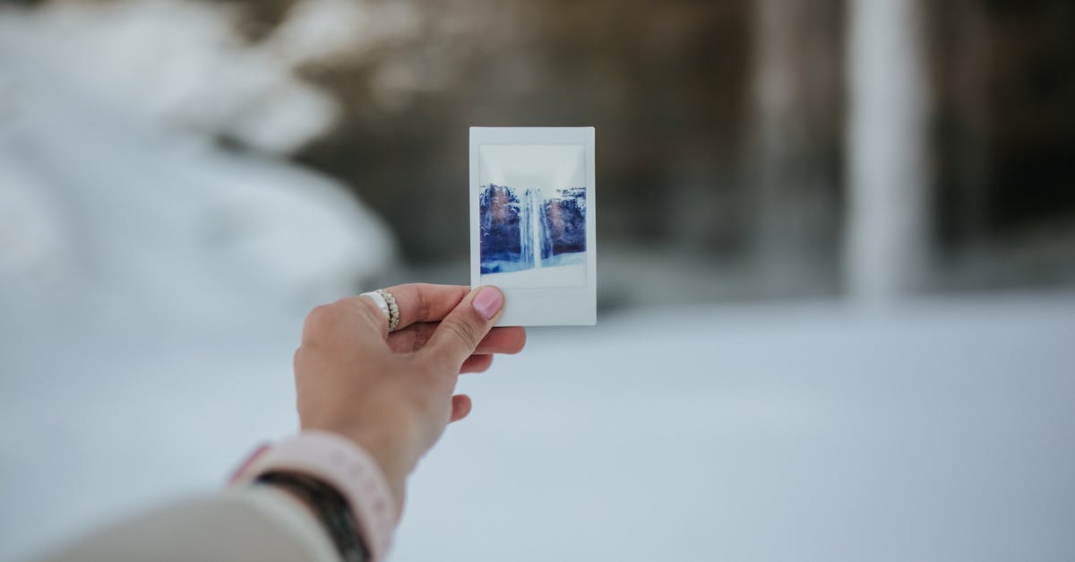 Photo of me holding my passport [closed] - A Person Holding a Photo of Waterfall