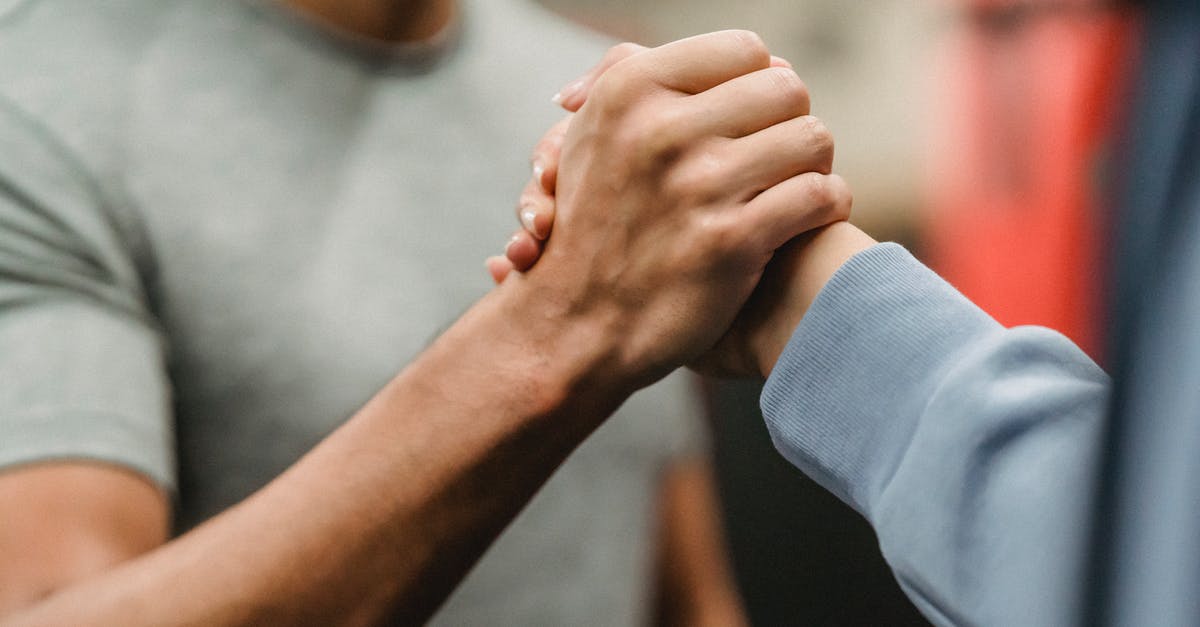 Physical (demanding) activities in Berlin - Crop sportive couple clasping hands in gym